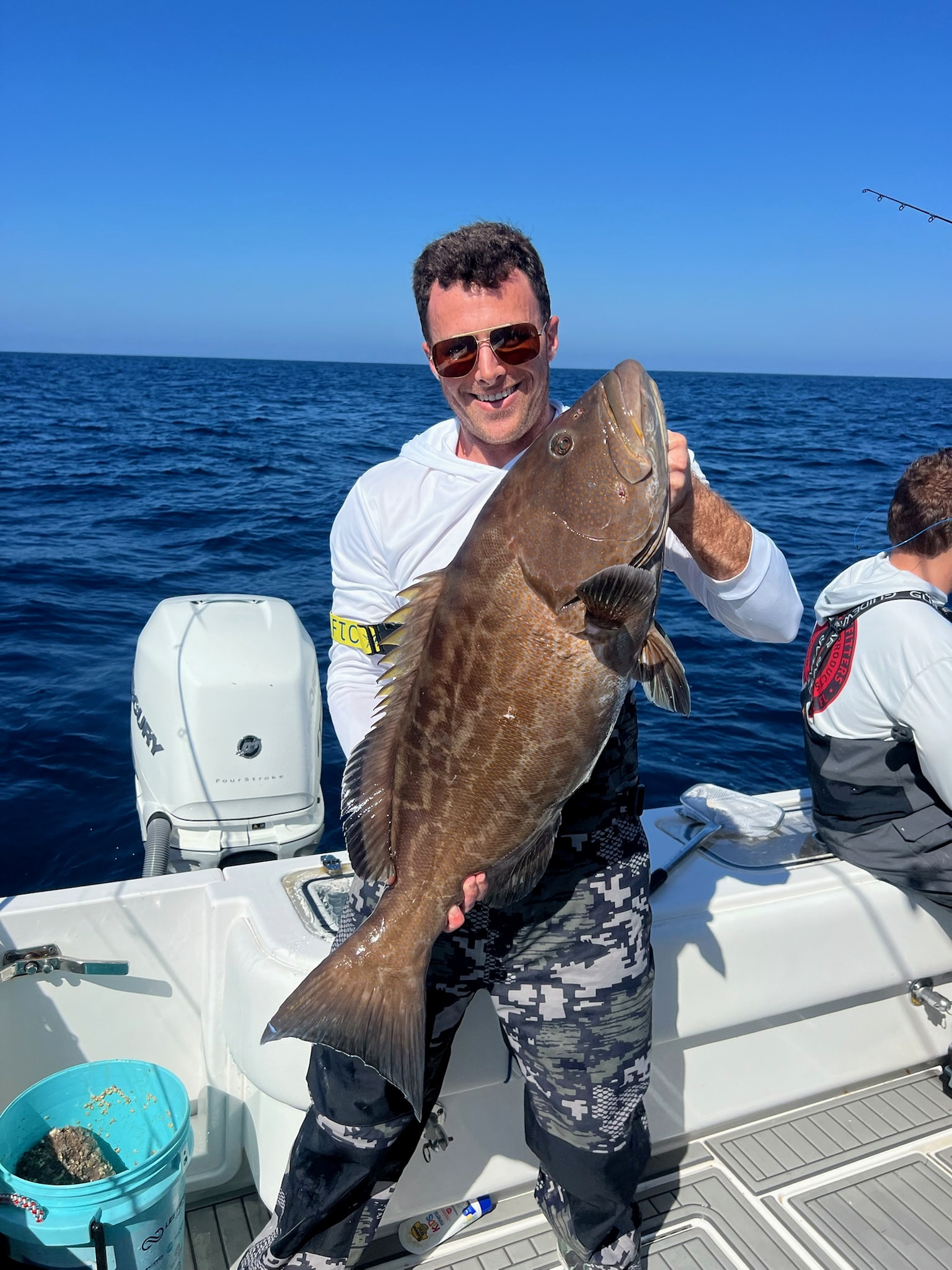 A big black grouper on the deck