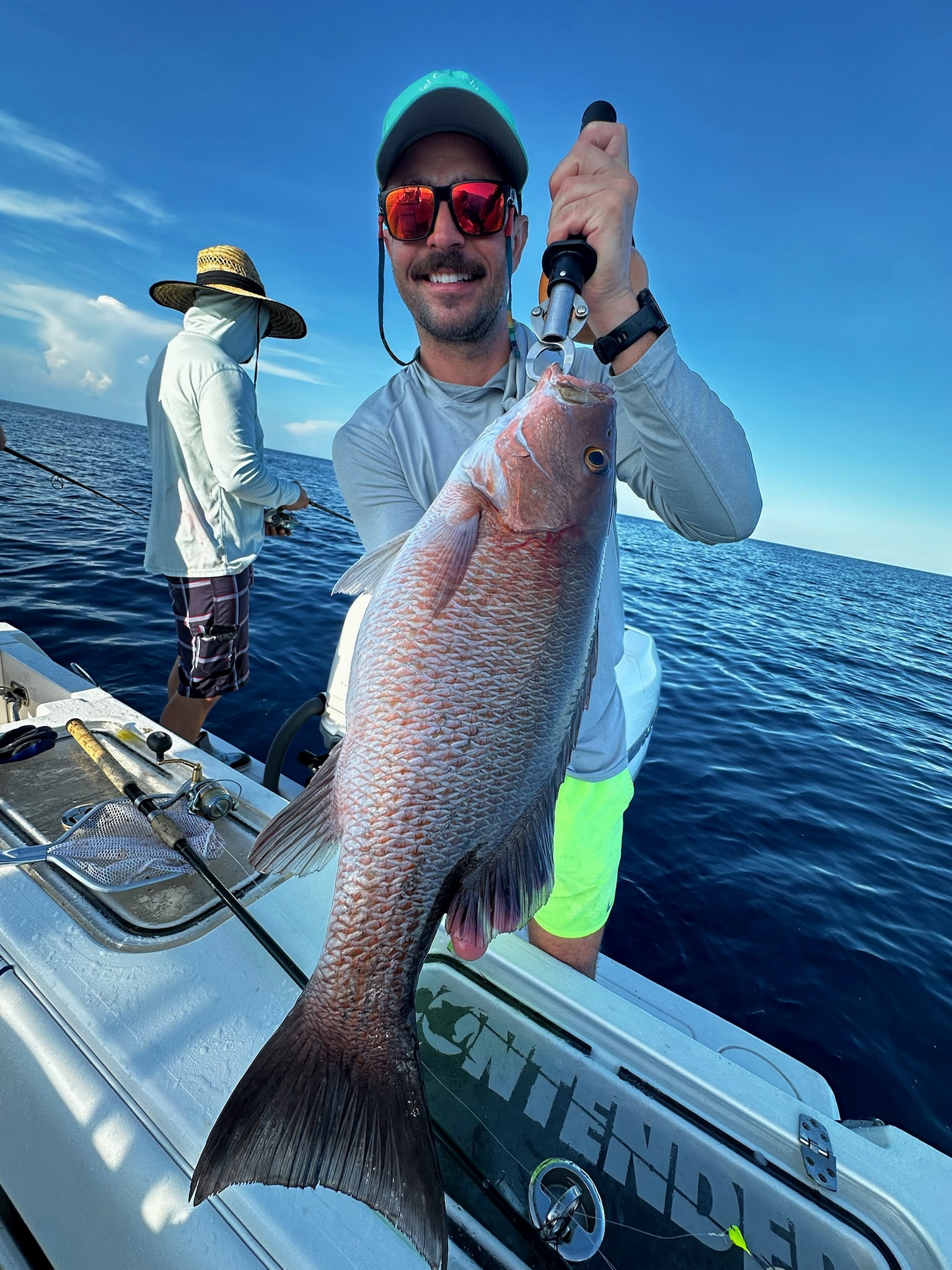 A mangrove snapper lifted aboard over the Contender's gunwale