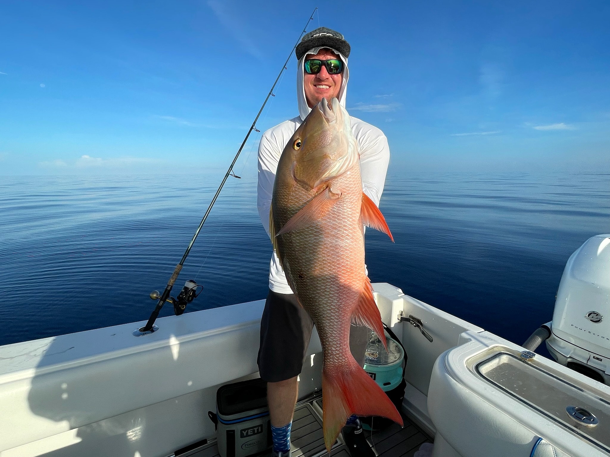 A mutton snapper on flat calm water
