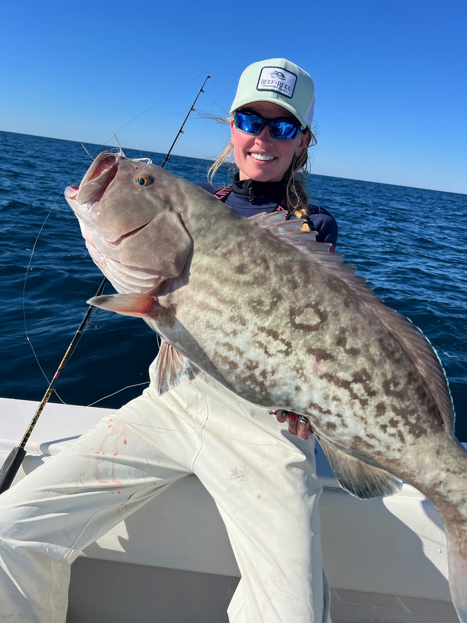 Angler with a speckled grouper offshore